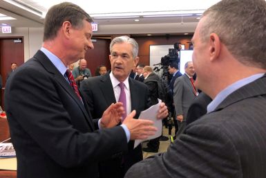Federal Reserve Chairman Jerome Powell speaks with Chicago Fed President Charles Evans and St Louis Fed President James Bullard at a conference on monetary policy at the Federal Reserve Bank of Chicago