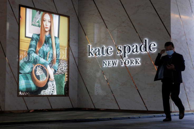 A man walks past a store of the Kate Spade luxury fashion retailer in a shopping district in Beijing