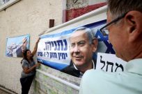 Israelis hang a poster of Likud party Benjamin Netanyahu in the southern city of Beersheva, on October 25, 2022 ahead of Israel's November 1 election