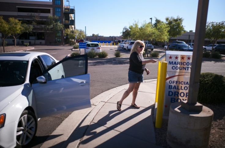 Arizona officials have expressed concern after individuals in tactical gear were found watching over a mail-in ballot box