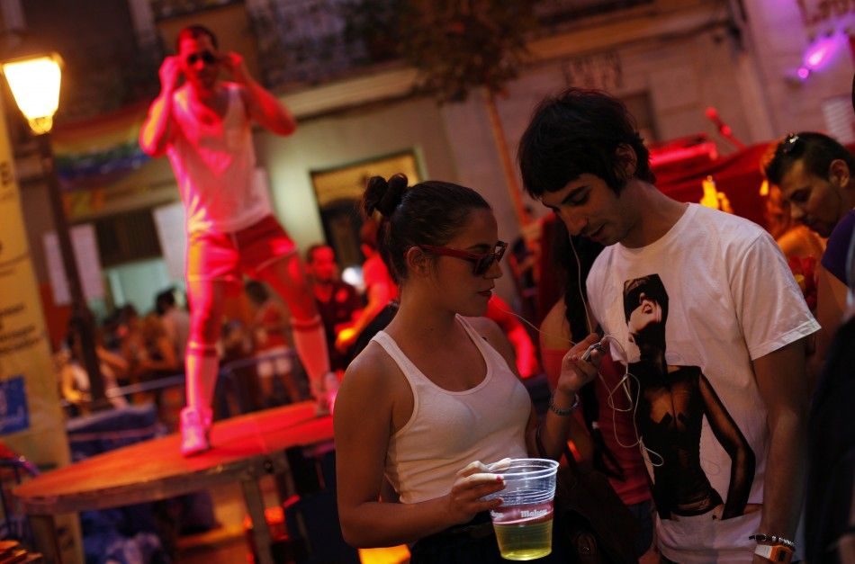 People listen to music on earphones through their smartphone during the quotSilent Discoquot, as part of Gay Pride celebrations in the quarter of Chueca in Madrid