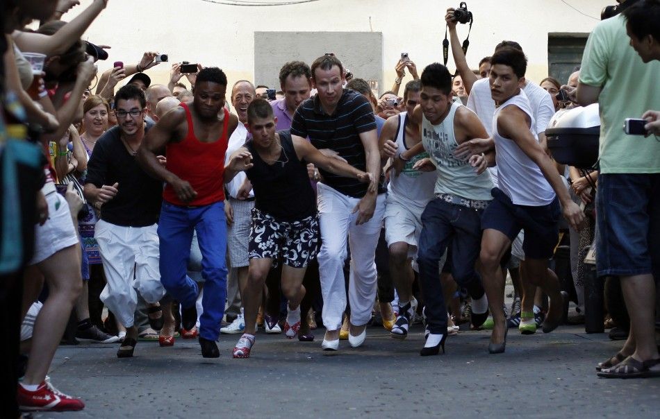 Contestants take part in the annual race on high heels during Gay Pride celebrations in the quarter of Chueca in Madrid