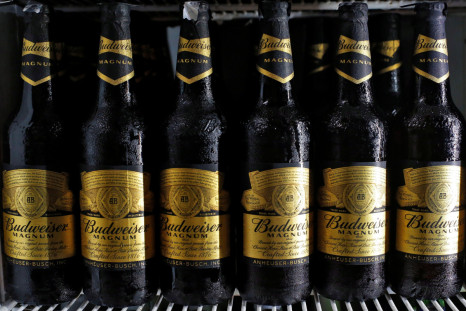 Budweiser beer bottles are seen in a cooler at a liquor shop in Kolkata