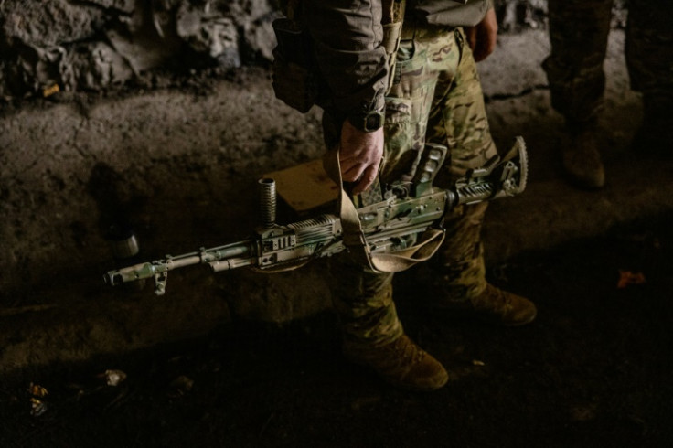 A Ukrainian soldier holds his assault rifle in the town of Bakhmut on October 23, 2022