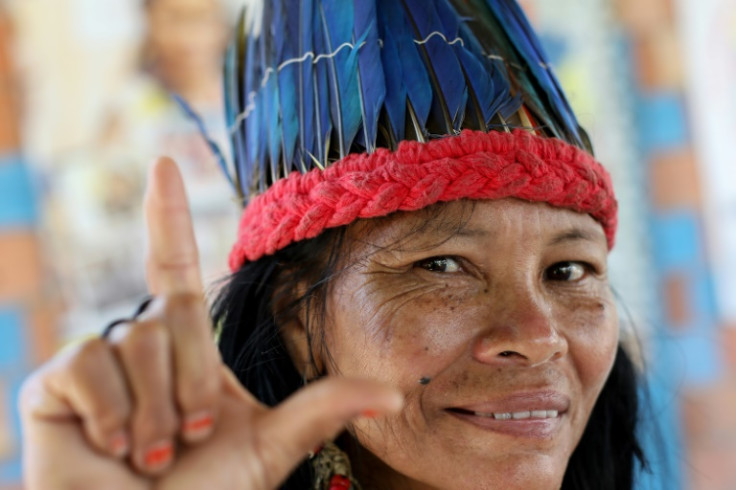 Lutana Ribeiro, from Brazil's Kokama tribe, flashes the "L" sign in support of leftist presidential candidate Luiz Inacio Lula da Silva on October 27, 2022