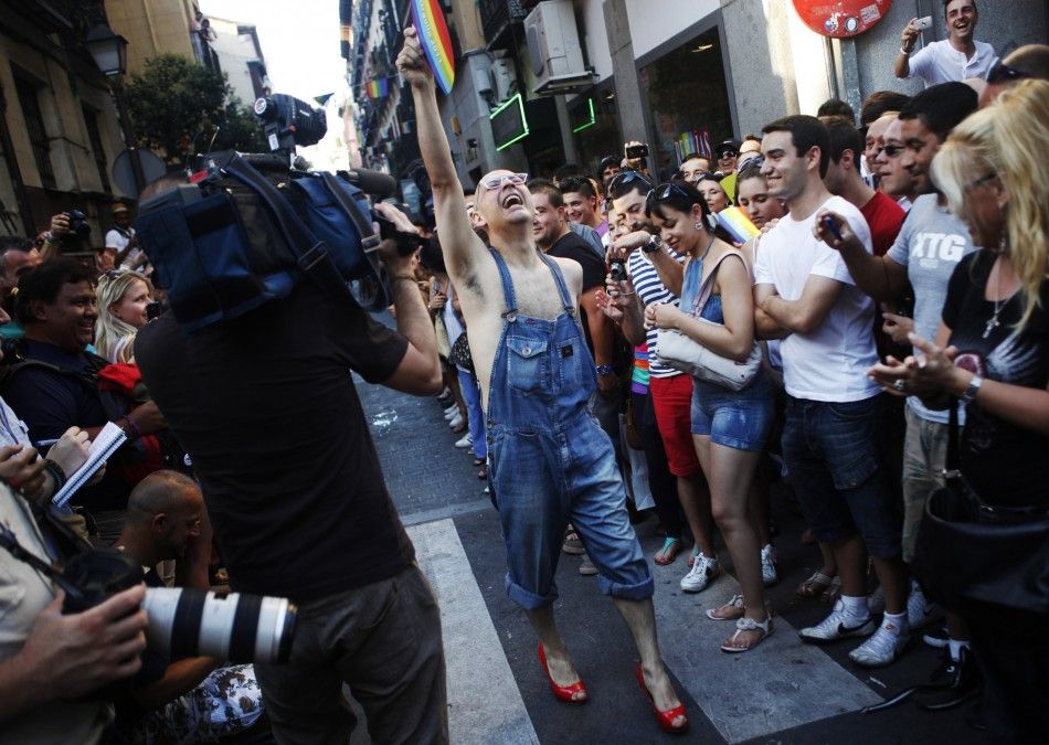 A contestant celebrates finishing the annual race on high heels after losing one of his shoes at the start of the race during Gay Pride celebrations in the quarter of Chueca in Madrid