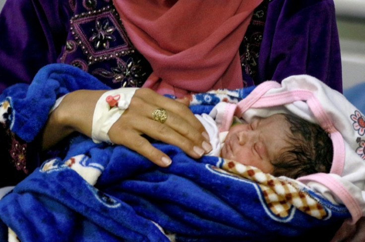 A mother and her newborn baby at the UNFPA-supported Sexual and Reproductive Health (SRH) clinic in the Zaatari camp for Syrian refugees