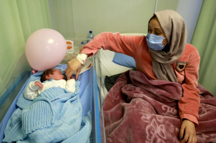 Syrian refugee Nagham Shagran, 20, watches over her newborn baby Zaid. At least 168,500 Syrian babies have been born in Jordan since 2014, according to the UN