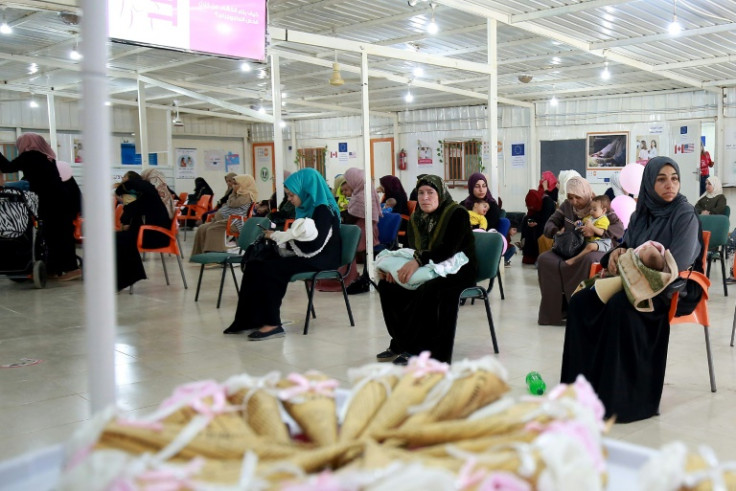 Syrian women wait for a consultation at a clinic in the Zaatari camp: the maternity ward  -- the camp's biggest health facility with 60 staff -- has 10 beds