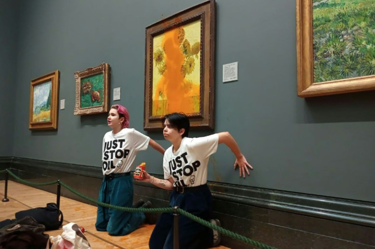 Two protesters hit Vincent van Gogh's 'Sunflowers' with tomato soup in London, but the painting was unharmed