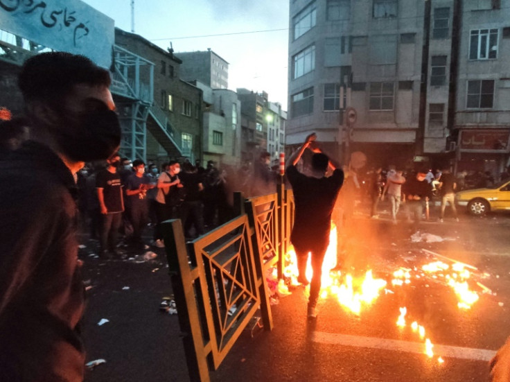 A picture obtained by AFP outside Iran on September 21, 2022, shows Iranian demonstrators taking to the streets of the capital Tehran during a protest for Mahsa Amini, days after she died in police custody