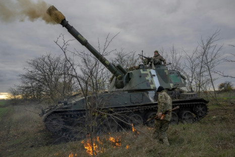 Ukrainian artillery unit members fire towards Kherson on October 28, 2022, outside of Kherson region