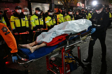 The body of a victim of a Halloween stampede is carried on a stretcher in Seoul on October 30, 2022