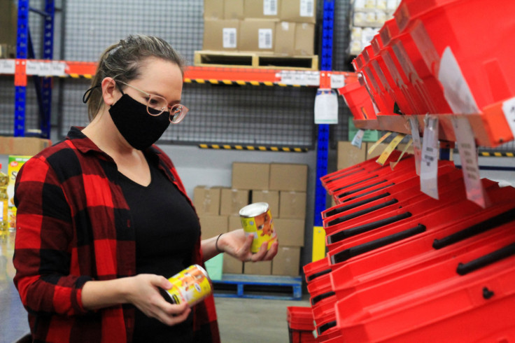 A volunteer sorts through donated canned goods at the Ottawa Food Bank warehouse in Ottawa