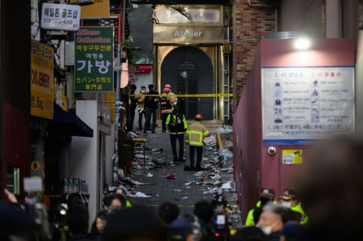 Emergency service personnel are seen in the narrow alley in Itaewon district where a stampede took place, killing more than 150 people