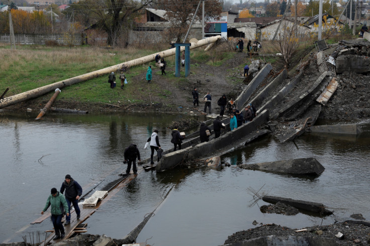 People come out of their underground shelters to receive aid, in Bakhmut