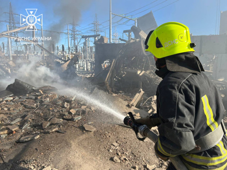 Firefighters work to put out a fire at energy infrastructure facilities, damaged by a Russian missile strike in Kyiv region in Ukraine