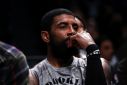 Brooklyn Nets star Kyrie Irving looks on from the bench during an NBA game against the Chicago Bulls