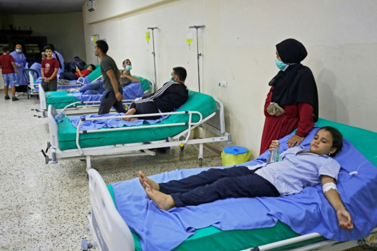 Patients receive treatment for Vibrio cholerae at a mosque hall converted into a field hospital in Bebnine, north Lebanon