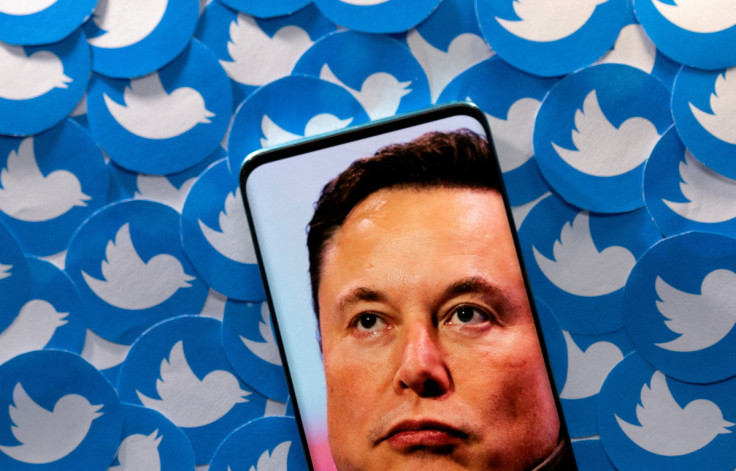 Illustration shows Elon Musk image on smartphone and printed Twitter logos