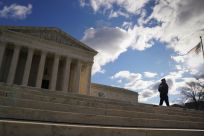 A police officer patrols in front of the U.S. Supreme Court  in Washington