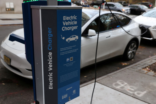 A electric vehicle charger is seen as a vehicle charges in Manhattan, New York