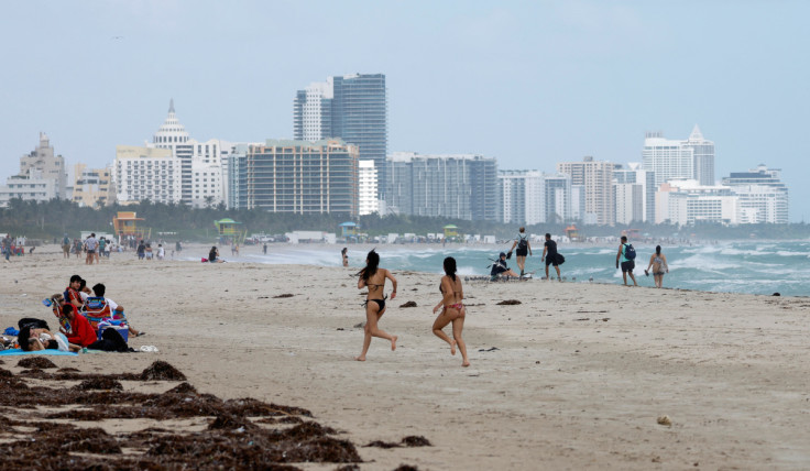 Beachgoers are shown as tropical storm Nicole approaches the state in Miami Beach