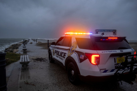 A police car blocks the entrance to the Inlet State Park before the expected arrival of Hurricane Nicole in Fort Pierce
