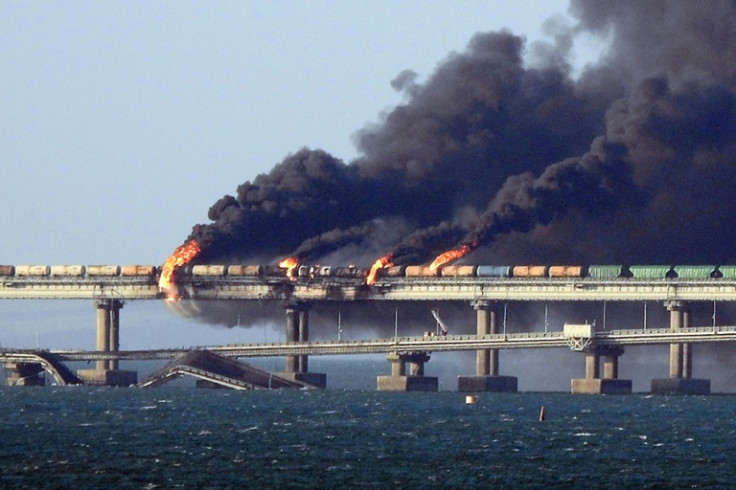 Black smoke billows from a fire on the Kerch bridge that links Crimea to Russia, after a truck exploded, near Kerch, on October 8, 2022