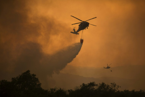 National Guard helicopters fight a wildfire in California; the rising number of such fires in the United States is increasing demands on troops