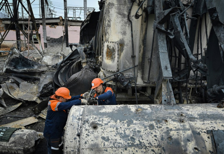 Employees work on damaged equipment at a high-voltage substation of the operator Ukrenergo after a missile attack, in central Ukraine