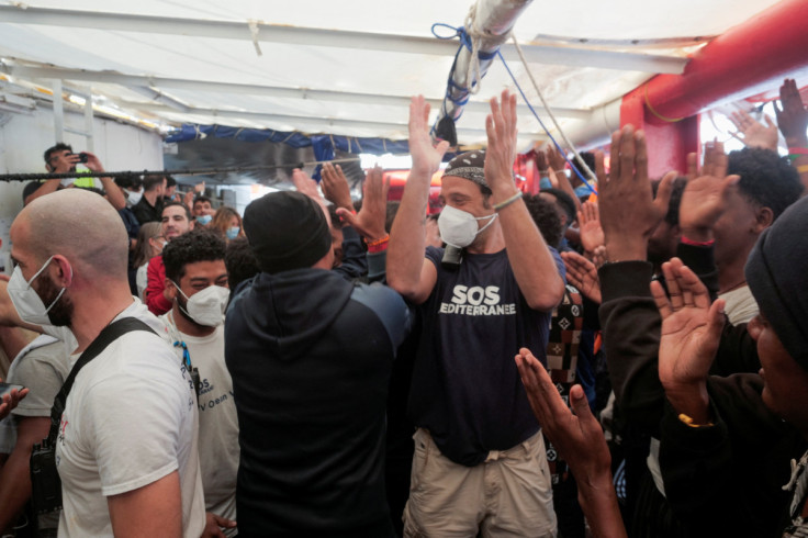 Migrants wait to disembark, weeks after their rescue, on board the rescue ship 'Ocean Viking', in the Mediterranean Sea