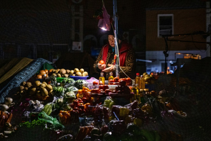 A vendor waits for customers during a power cut at Bessarabsky market in Kyiv