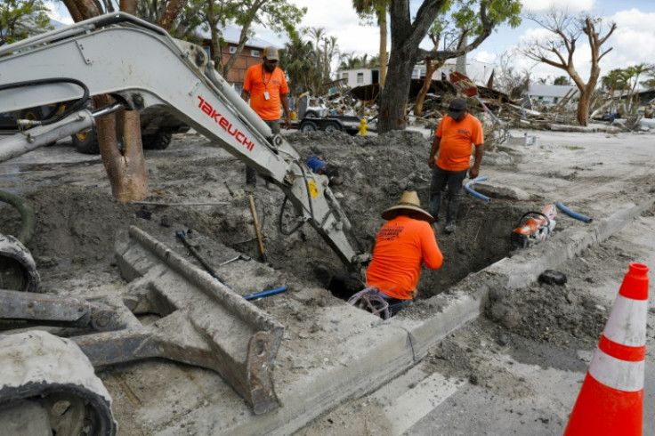 Construction workers toil to restore services on Fort Myers Beach, Florida, on November 2, 2022