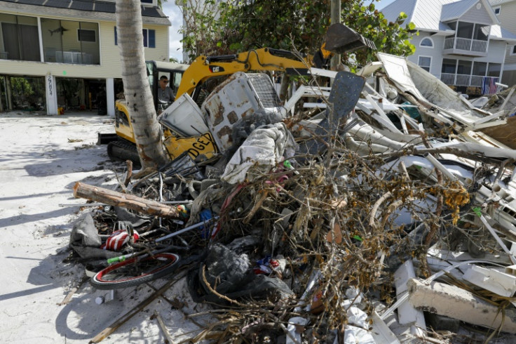 A laborer uses heavy machinery to remove rubble in Bonita Springs, Florida, on November 2, 2022