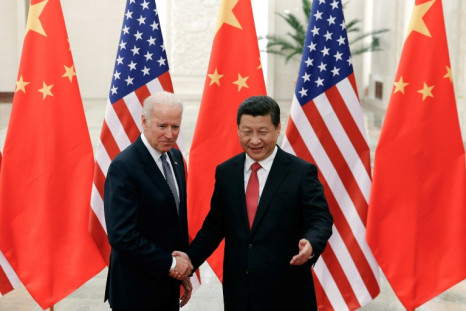 Chinese President Xi Jinping shakes hands with then US vice president Joe Biden inside the Great Hall of the People in Beijing on December 4, 2013