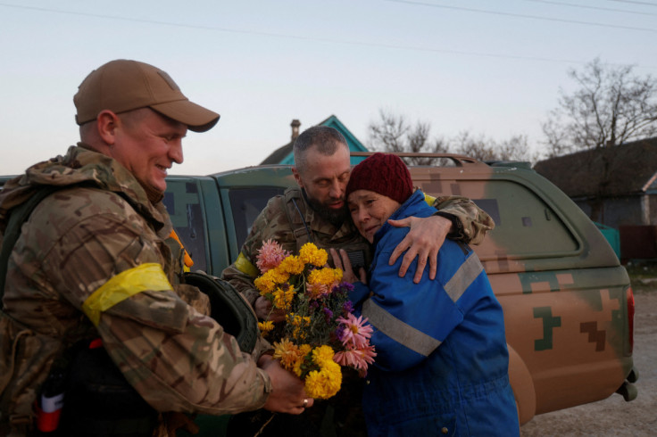 Local resident Valentyna Buhaiova embraces Ukrainian marines in the recently retaken village of Kyselivka, outside of Kherson