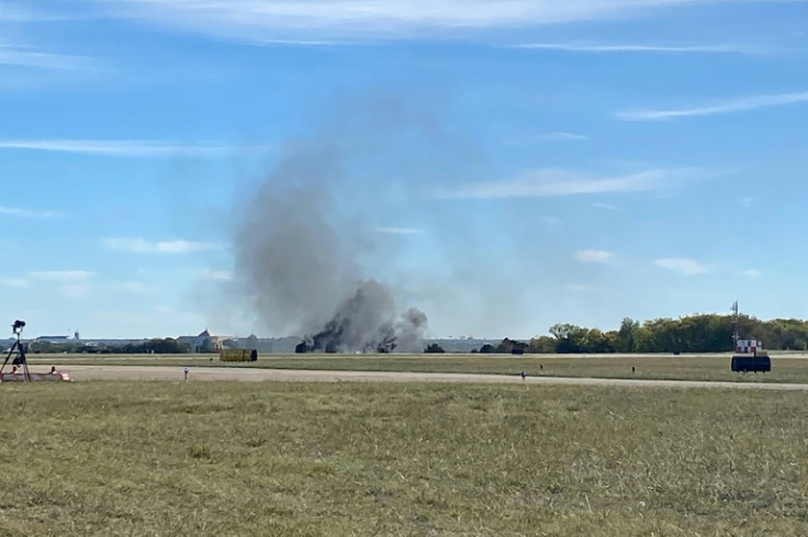 Smoke rises from the crash site after two planes collided mid-air during the Wings Over Dallas Airshow on November 12, 2022