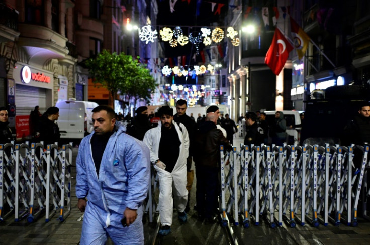 Turkish policemen secure the area after a blast in Istanbul