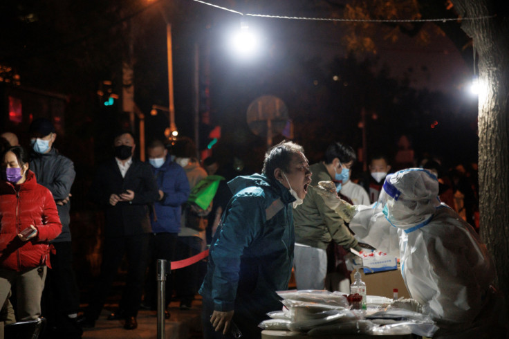 A man gets a swab tests at a temporary testing station as outbreaks of COVID-19 continue in Beijing