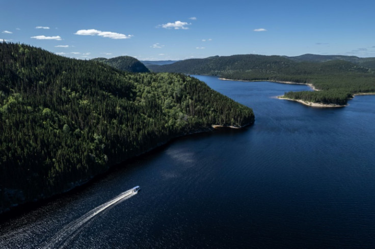 An aerial view shows the boat of caribou researcher Jean-Luc Kanape, a member of the Innu Indigenous group, on a waterway in Canada's boreal forest