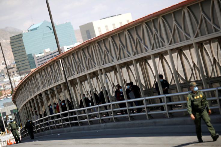 Migrants expelled from U.S. and sent back to Mexico walk across border bridge in Ciudad Juarez