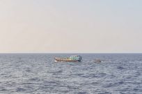 U.S. naval forces approach a fishing vessel 