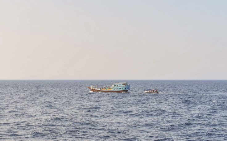 U.S. naval forces approach a fishing vessel 