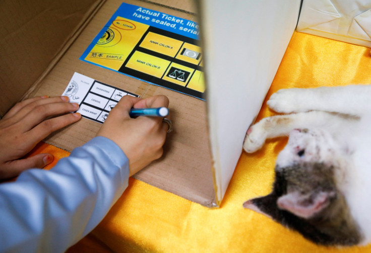 An undergraduate marks her ballot paper during a mock-up election ahead of Malaysia's upcoming general election at Gombak