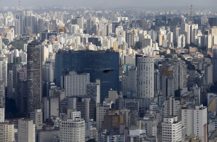 A helicopter flies over the skyline of Sao Paulo