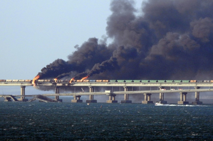 Black smoke billows from a fire on the Kerch bridge that links Crimea to Russia, after a truck explosion in October