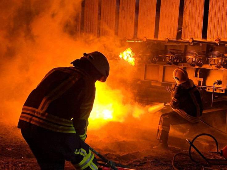 Firefighters work to put out a fire at energy infrastructure facilities, damaged by a Russian missile strike in Kyiv region