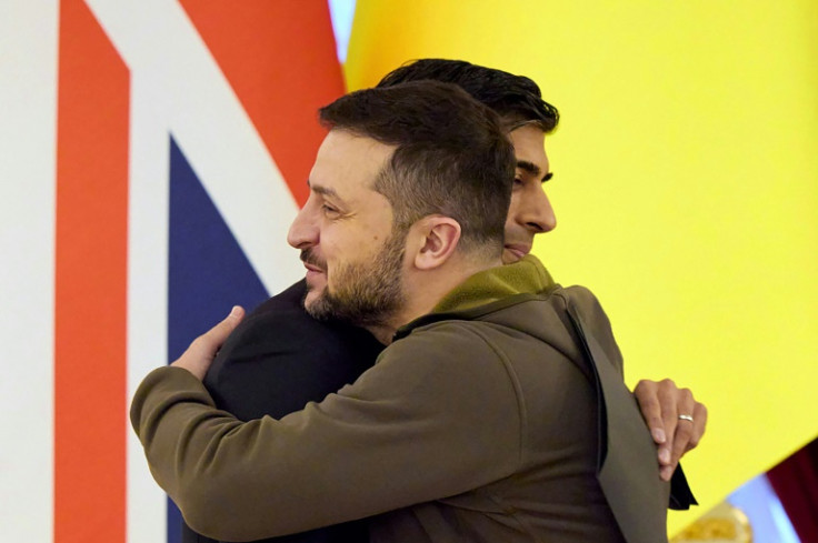 Ukrainian President Volodymyr Zelensky embraces British Prime Minister Rishi Sunak as the latter vows to stand by Kyiv "until Ukraine has won"