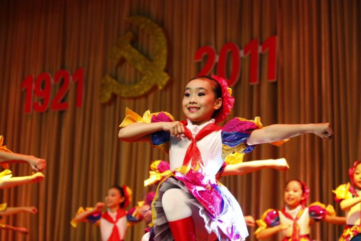 Children perform at a revolutionary song singing event to celebrate the upcoming 90th anniversary of the founding of the Communist Party of China, in Shanghai